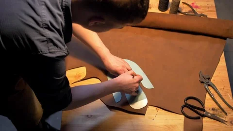 Man draws a shoe with pencil on a table Stock Footage 126717032