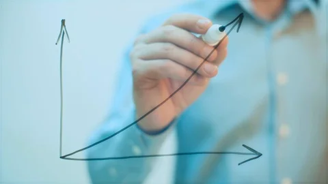 Man draws on transparent screen Growth Graph Stock Footage 128000094