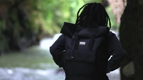 A Man With Dreadlocks Climbing Down a Stair and Start Wandering After Stock Footage 208059820