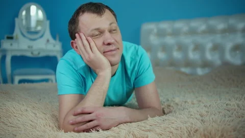 Man dreaming while lying on bed in the early morning Stock Footage 145480209