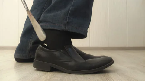 Man dress shoes properly using shoehorn, Stock Footage 39719637