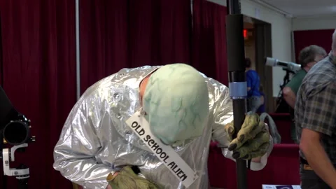 Man dressed as alien at the AstroCon astronomy convention in 2017. Stock Footage 313344354