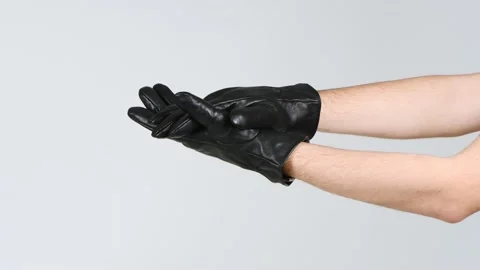 A man dressed in black gloves claps his hands. Side view. Stock Footage 168482097