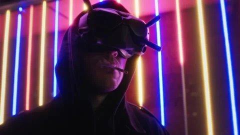 Man dressed in cyberpunk style uses VR artificial intelligence technology Stock Footage 253061422