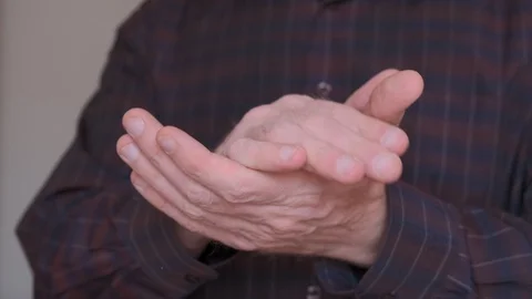 Man dressed in a dark shirt clapping to the beat. Slow-motion. Stock Footage 105991369