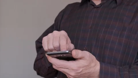 Man dressed in a dark shirt using smartphone. Slow-motion. Stock Footage 105992807