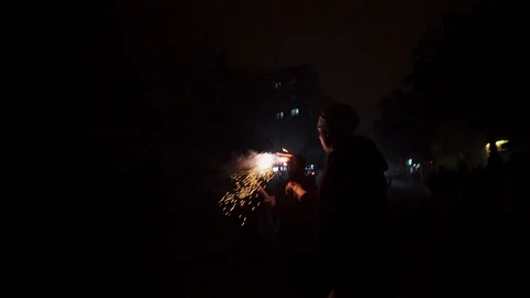 A man dressed as devil lights a firework before running in to the crowd Video stock 100377960
