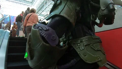 Man dressed up as lex luthor going up escalator Video stock 148517771