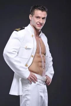 A man dressed as a pilot on grey background Stock Photos
