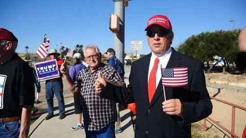 A man dressed up as President Donald Trump at a support rally Stock Footage 73125070