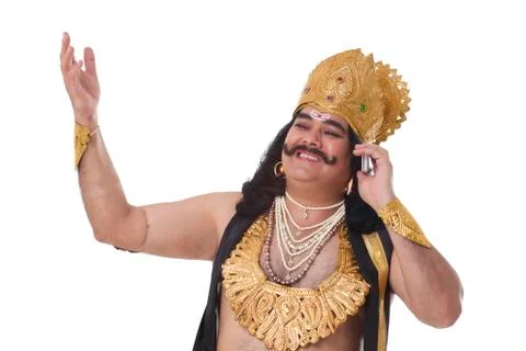 Man dressed as Raavan talking on a mobile phone Stock Photos