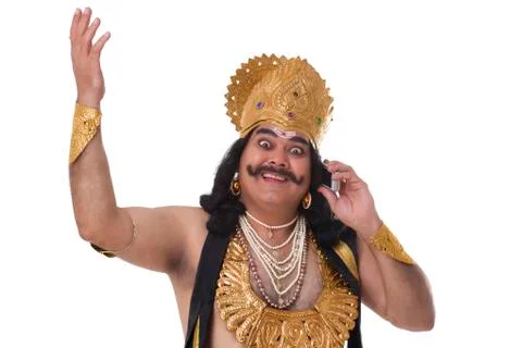 Man dressed as Raavan talking on a mobile phone Stock Photos