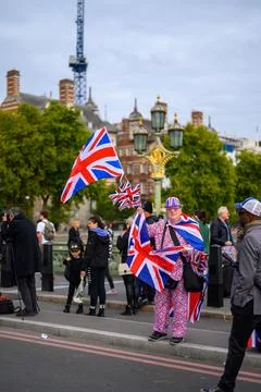 Man dressed in Union Jack flags sells souvenirs Stock Photos