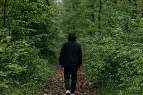 A man dressed in  walks through the forest Stock Photos