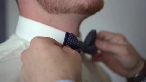 Man dresses a bow tie Stock Footage 82781125