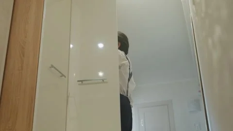 Man dresses professionally. Preparing for work in apartment. Asian gentleman Stock Footage 342057293