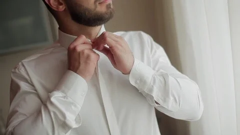Man dressing close-up. Male hands button white shirt collar Stock Footage 72597573