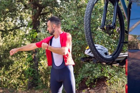 Man dressing next to his van to go cycling Stock Photos