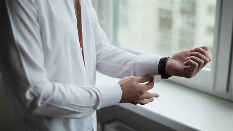 Man dressing white shirt close up. Male hands button sleeves wear formal clothes Stock Footage 71006983