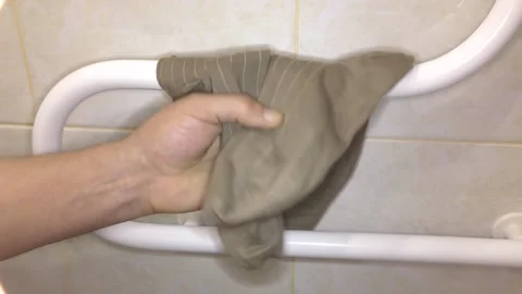 Man dries socks on a drying coil. Stock Footage 132730863