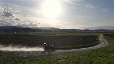 A man drifting ATV through sandy corner on a sunny day Stock Footage 152147953