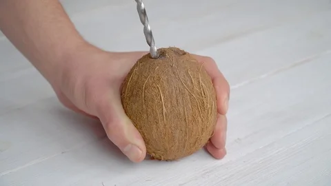 Man drilling a coconut Stock Footage 104342974