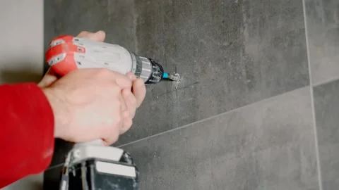 A man is drilling in granite with a screwdriver. Stock Footage 134238655