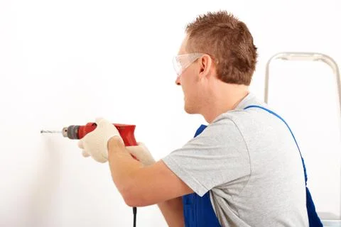 Man drilling hole Stock Photos