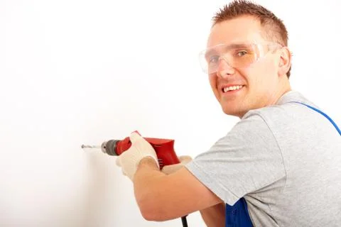 Man drilling hole Stock Photos