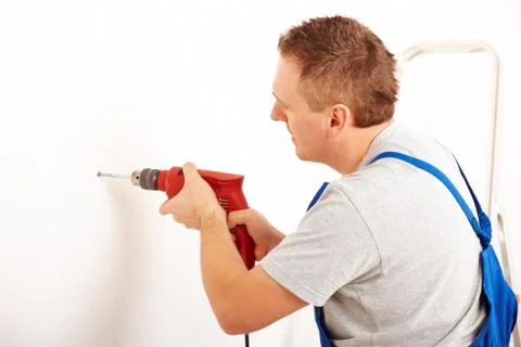 Man drilling hole Stock Photos