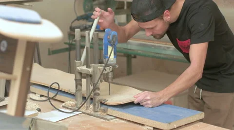 Man drilling holes into the longboard Stock Footage 58300267