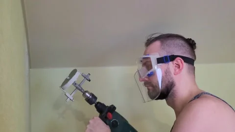 The man is drilling the wall. Stock Footage 233359984