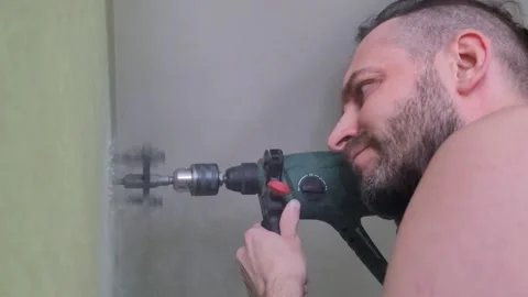 The man is drilling the wall. Stock Footage 233359985