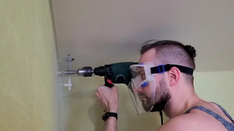 The man is drilling the wall. Stock Footage 233360077