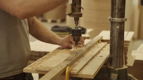 A man drills a board on a machine Stock Footage 128369617