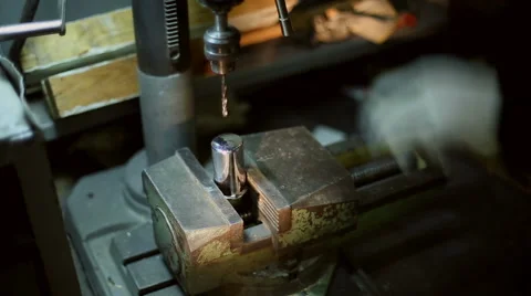 Man drills a detail on a drilling machine Stock Footage 59596768