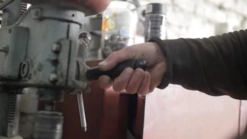 Man drills on a drilling machine Stock Footage 130710990