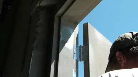 Man Drills Hinges on Door Stock Footage 12594839