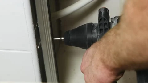 Man drills hole in construction for connecting with wall Stock Footage 304404763