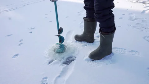 Man drills ice with augers. Stock Footage 236704573