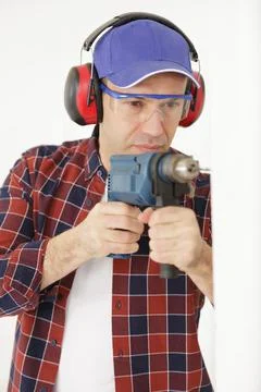 Man drills a wall with a drill Stock Photos