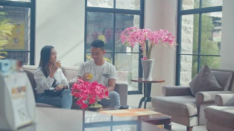A Man Drink and Talking To His Girlfriend In The Lobby Stock Footage 162288656