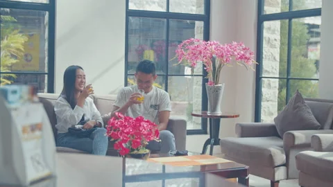 A Man Drink and Talking To His Girlfriend In The Lobby Stock Footage 162289228