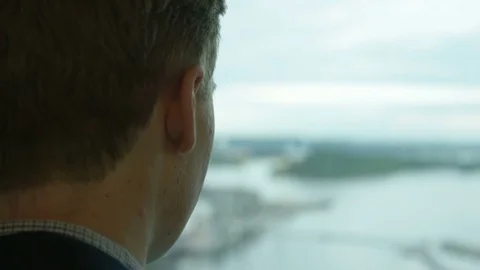 Man drink coffee close to the window at his workplace Stock Footage 75492388