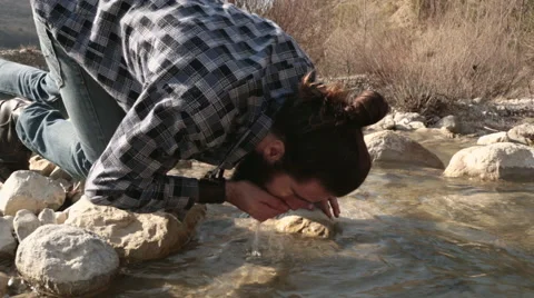 Man drink from river Video stock 64576202