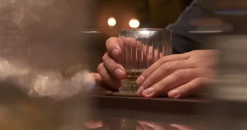Man drinking alcohol at the bar. Alcohol addiction problem. Close-up glass of Stock Footage 257975295