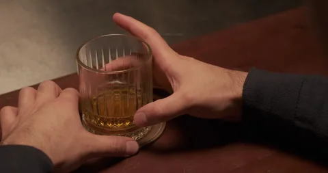Man drinking alcohol at the bar. Alcohol addiction problem. Close-up hands with Stock Footage 260007024