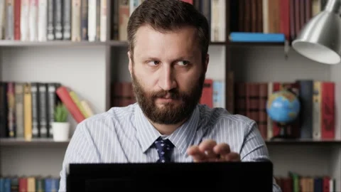 Man drinking alcohol. Bearded man at workplace pours whiskey brandy bourbon tape Stock Footage 133485622