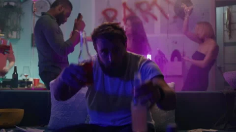 Man drinking alcohol during party on sofa 스톡 동영상 163633484
