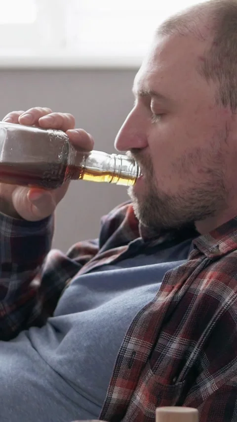 Man drinking alcohol, symbolizing addiction and depression. Видео 329623596
